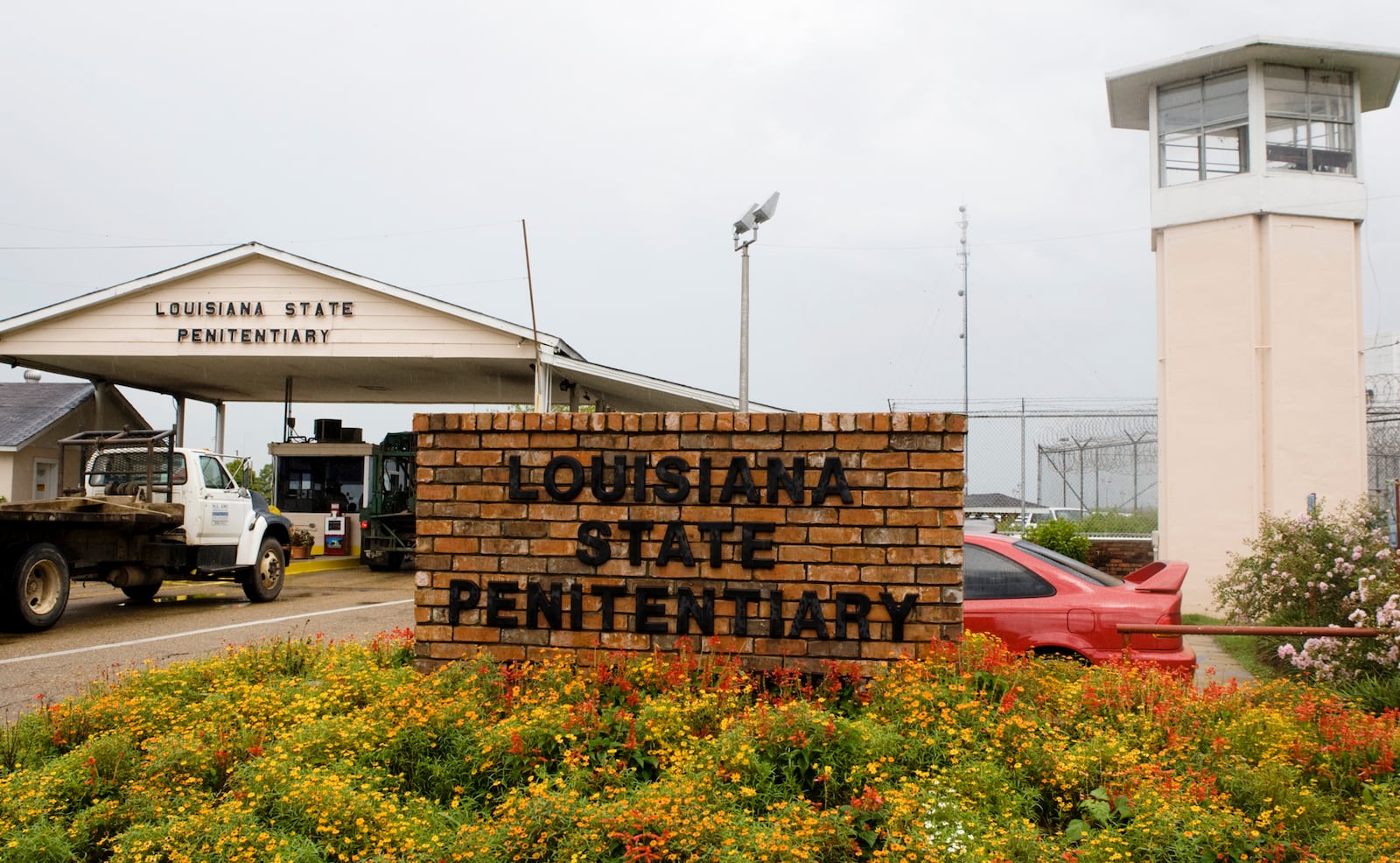 FILE - Vehicles enter at the main security gate at Louisiana State Penitentiary in Angola, La., Aug. 5, 2008. (AP Photo/Judi Bottoni, File)