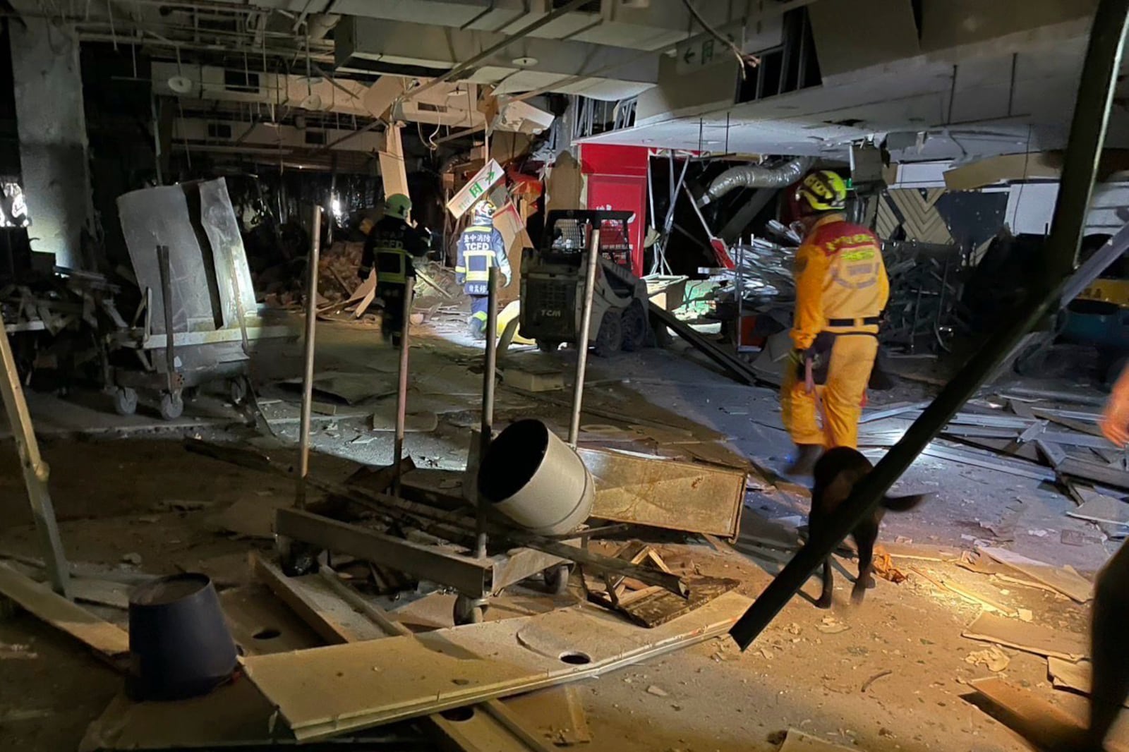 In this photo taken and released by Taichung Fire Bureau, first responders survey the damage in the aftermath of an explosion at the Shin Kong Mitsukoshi department store in Taichung city in Taiwan on Thursday, Feb. 13, 2025. (Taichung Fire Bureau via AP)