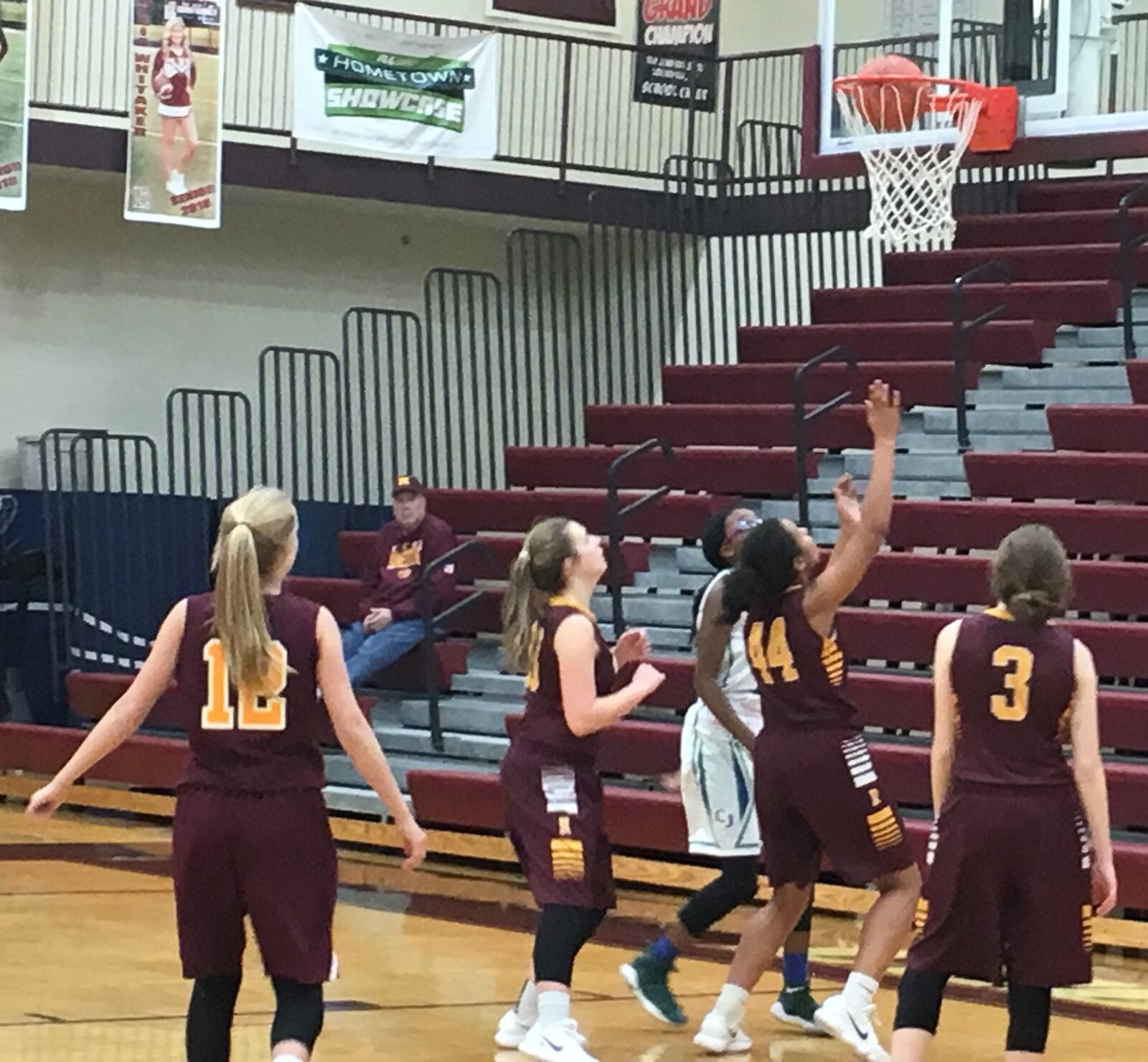 Charlotte Spencer (12), Dakota Snyder (33), Sydney Shaw (44) and Julia Nunn (3) of Ross watch a shot by Chaminade Julienne’s Dallas Harris go through the hoop during Saturday’s Division II sectional game at Lebanon. RICK CASSANO/STAFF