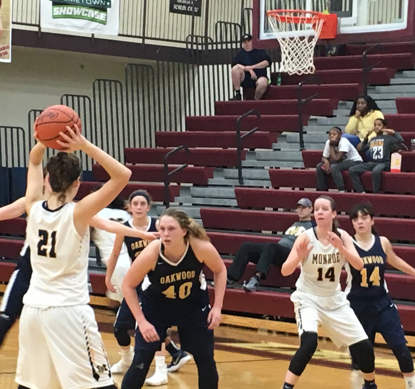 Monroe’s Alyssa Beckett (21) looks toward teammate Sophie Sloneker (14) as Oakwood’s Kyndall Ketterer (40) and Lauren Hapgood (14) defend during Tuesday night’s Division II sectional semifinal at Lebanon. RICK CASSANO/STAFF