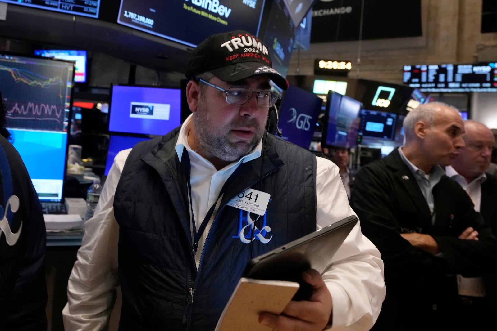 Trader Michael Capolino works on the floor of the New York Stock Exchange, Wednesday, Nov. 6, 2024. (AP Photo/Richard Drew)