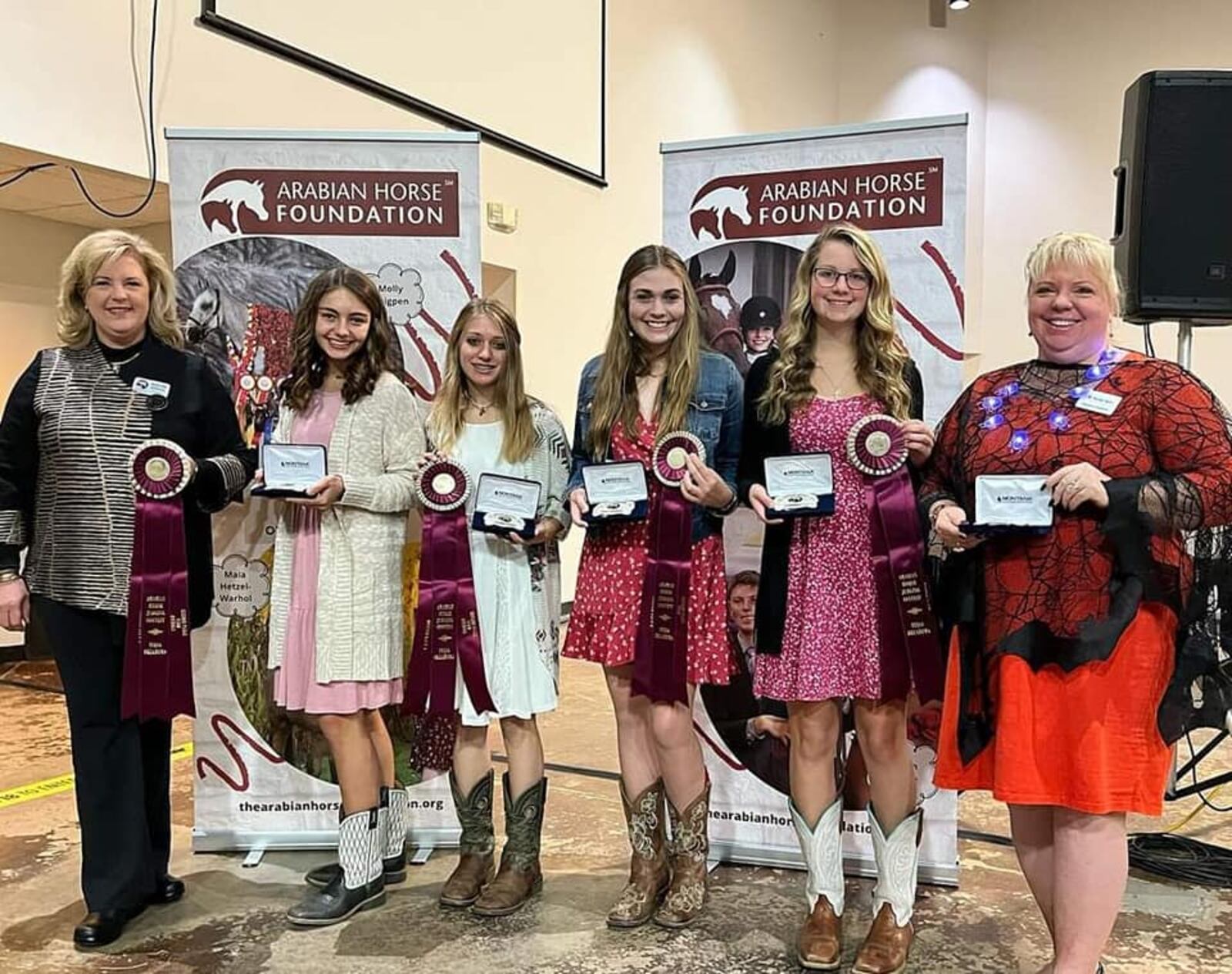 A National Arabian Horse Association representative, left, presents the second-place team award to the Talawanda/Butler Tech team. Members are, from left, sophomores Cecilia Guenther and Kayla Lightfield, junior Olivia Demoret, senior Olivia Zaenkert and Butler Tech Agriculture Innovative Teaching and Learning coach Heather Campbell-Lieberman, who traveled with the team. CONTRIBUTED