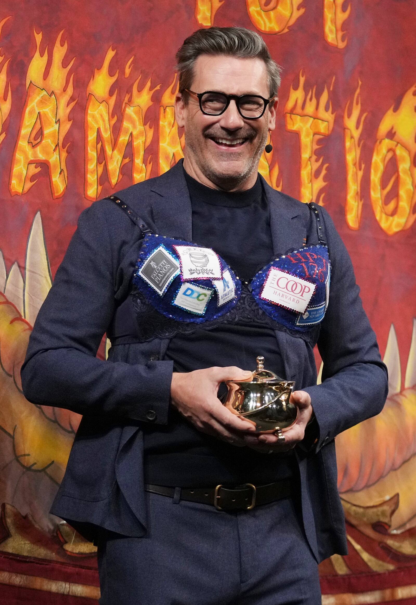 Harvard University's Hasty Pudding Theatricals Man of the Year Jon Hamm holds his award, Friday, Jan. 31, 2025, in Cambridge, Mass. (AP Photo/Charles Krupa)