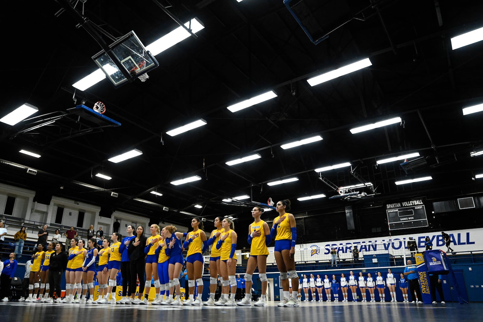 The San Jose State Spartans and Air Force Falcons stand for the National Anthem before an NCAA college volleyball match Thursday, Oct. 31, 2024, in San Jose, Calif. (AP Photo/Eakin Howard)