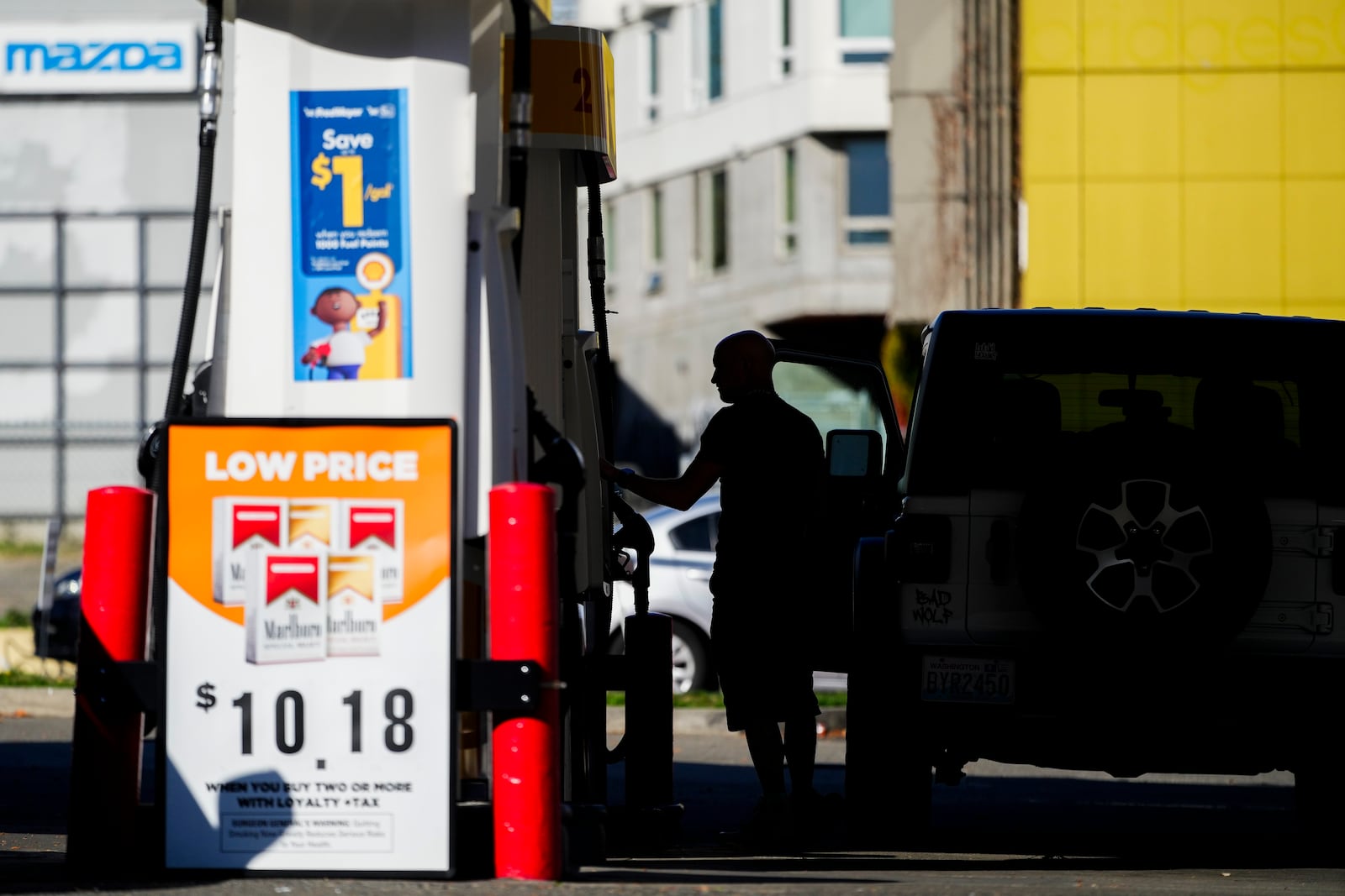 A driver fills up at a pump at a Shell gas station, Wednesday, Oct. 9, 2024, in Seattle. (AP Photo/Lindsey Wasson)