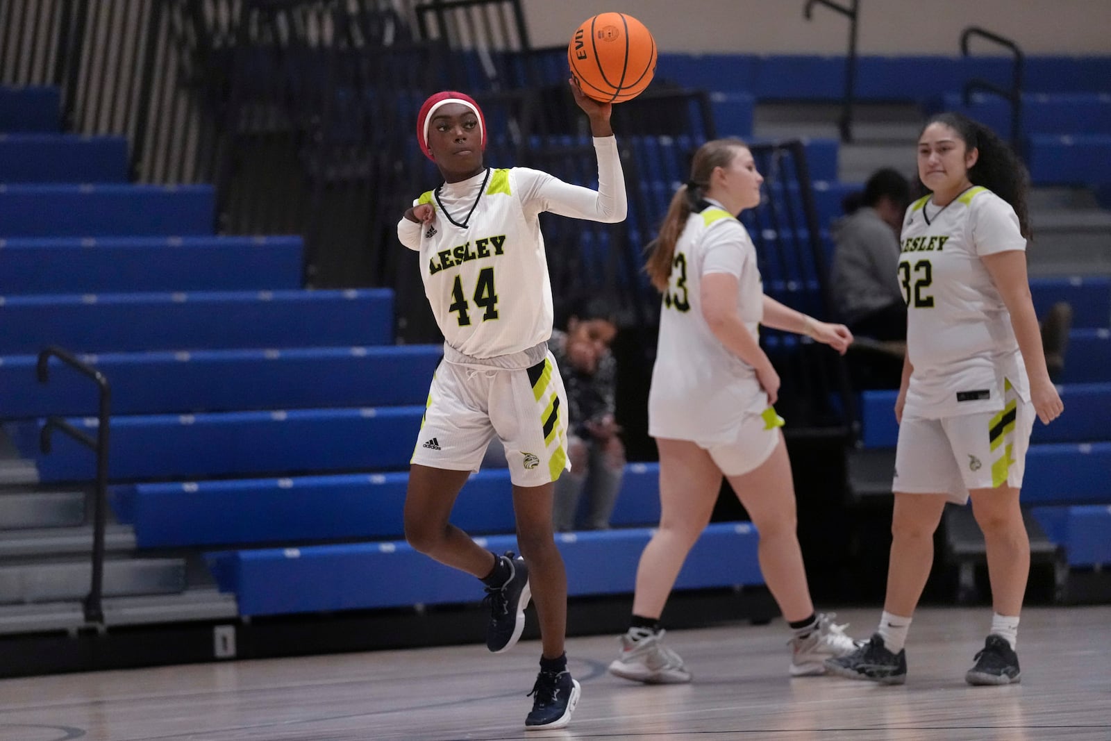 Lesley College basketball player Baileigh Sinaman-Daniel passes the ball while practicing prior to a game, Tuesday, Feb. 11, 2025, in Lexington, Mass. (AP Photo/Charles Krupa)