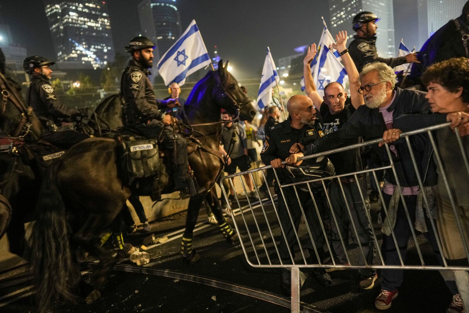 Israeli police try to push back protesters from a main road after Prime Minister Benjamin Netanyahu has dismissed his defense minister Yoav Gallant in a surprise announcement in Tel Aviv, Israel, Tuesday, Nov. 5, 2024. (AP Photo/Oded Balilty)