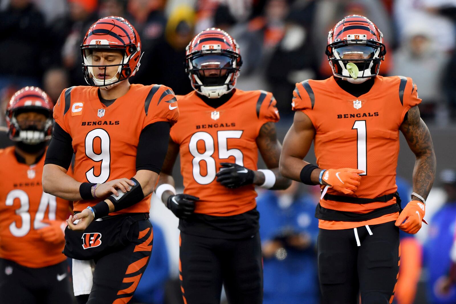 FILE - Cincinnati Bengals quarterback Joe Burrow (9), wide receiver Tee Higgins (85) and Cincinnati Bengals wide receiver Ja'Marr Chase (1) run onto the field during an NFL football game against the Kansas City Chiefs, Sunday, Dec. 4, 2022, in Cincinnati. The Bengals’ Burrow, Chase and Higgins have been a winning trio this year and Cincinnati fans should enjoy them while they can. Their days together could be numbered. Burrow will demand a huge contract next summer with Higgins and Chase knocking on the door soon after. (AP Photo/Emilee Chinn, File)