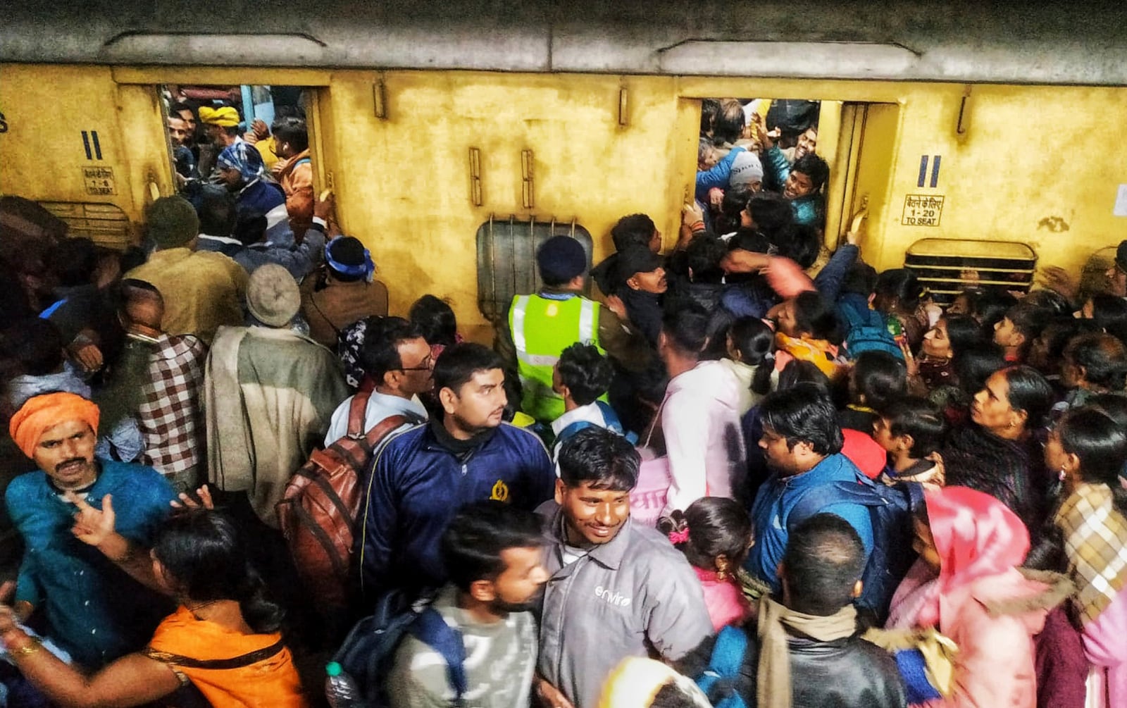 Passengers jostle with each other to board a train at the New Delhi Railway station, in New Delhi, India, Thursday, Feb.15, 2025. (AP Photo)