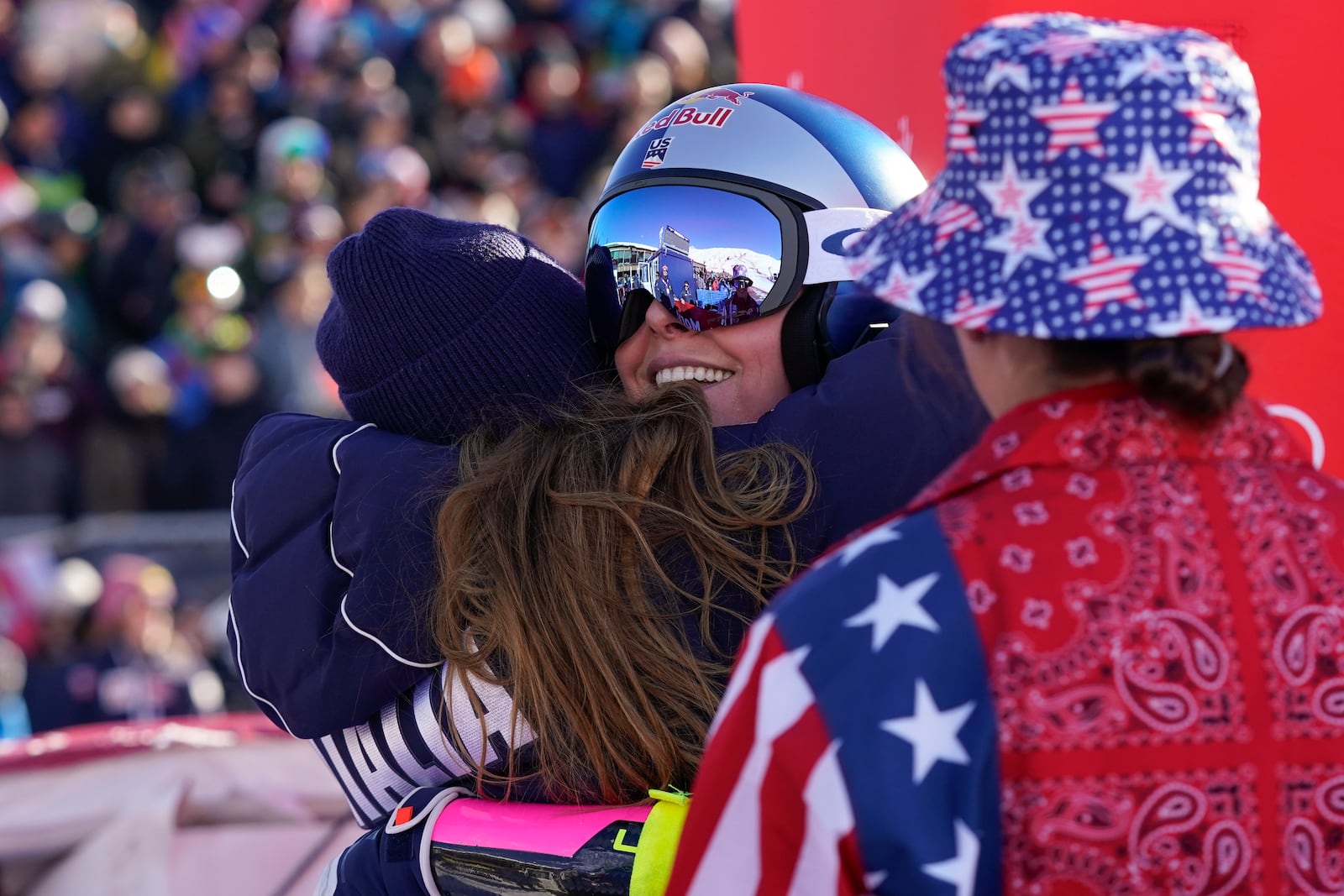 Italy's Sofia Goggia, left, hugs United States' Lindsey Vonn after Vonn competed in an alpine ski, women's World Cup super G, in St. Moritz, Switzerland, Saturday, Dec. 21, 2024. (AP Photo/Giovanni Auletta)