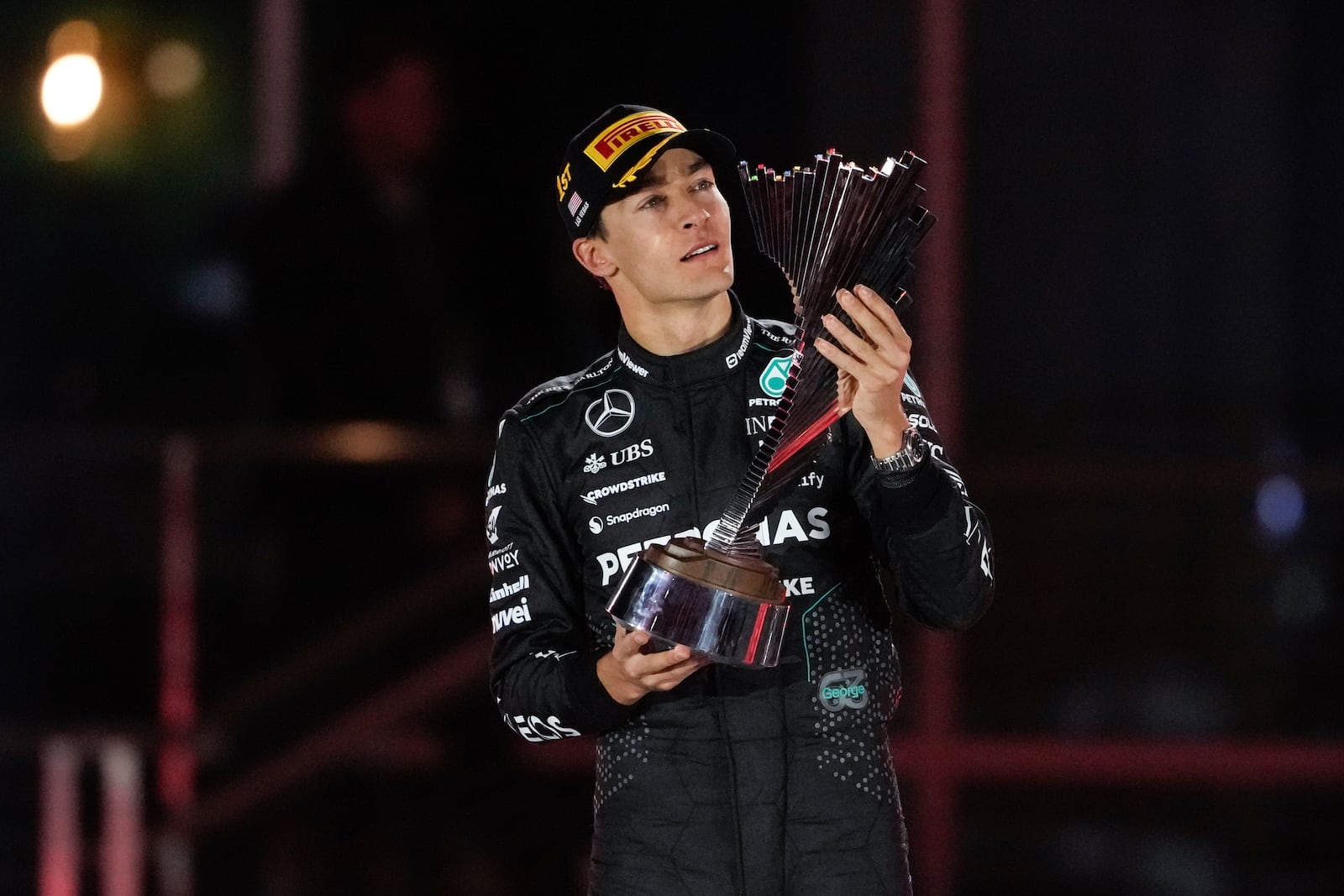 Mercedes driver George Russell, of Britain, celebrates on the podium after winning the F1 Las Vegas Grand Prix auto race, Sunday, Nov. 24, 2024, in Las Vegas. (AP Photo/Matt York)