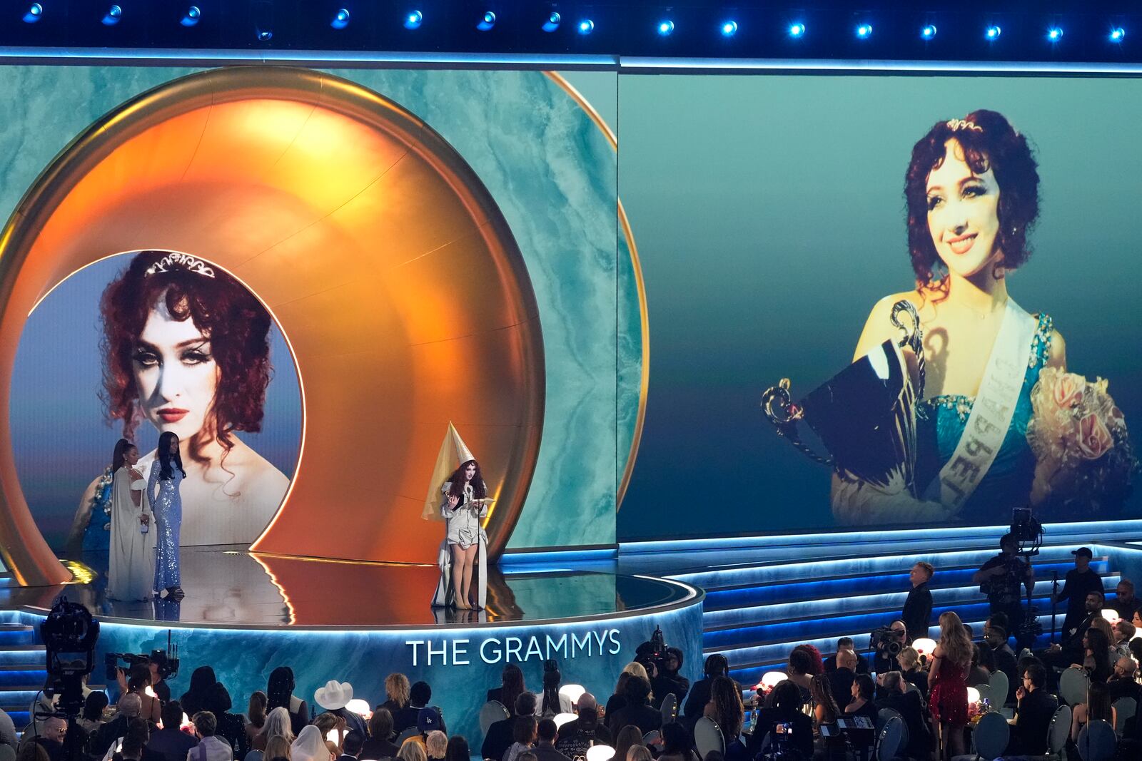 Chappell Roan accepts the award for best new artist during the 67th annual Grammy Awards on Sunday, Feb. 2, 2025, in Los Angeles. Victoria Monet looks on from left,(AP Photo/Chris Pizzello)