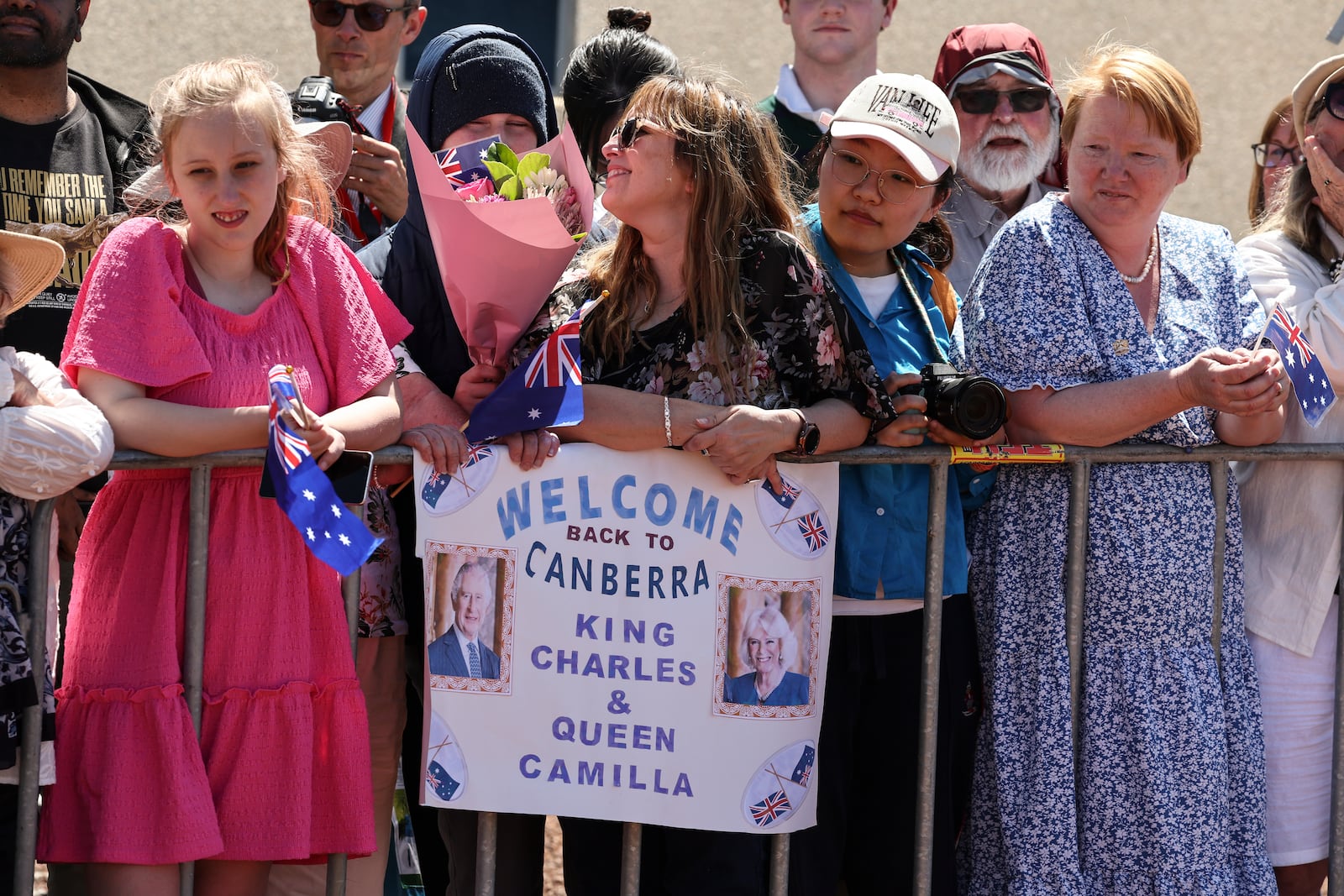 People wait to see Britain's King Charles III and Queen Camilla outside Parliament House in Canberra, Australia, Monday, Oct. 21, 2024. (David Gray/Pool Photo via AP)