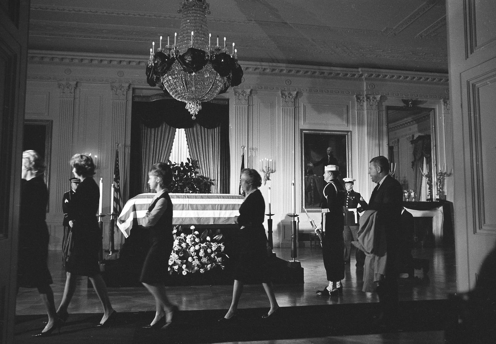 FILE - Members of the White House staff file past the body of John F. Kennedy, lying in repose in a closed, flag-draped coffin in the historic East Room of the Executive Mansion in Washington, Nov. 23, 1963. (AP Photo/Henry Burroughs, File)