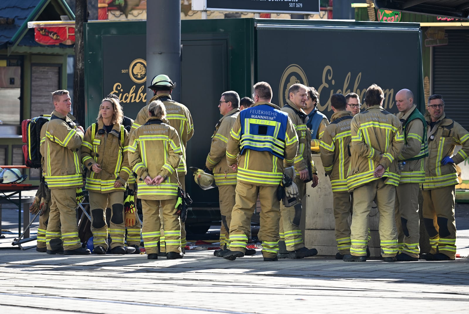 Emergency workers stand by during a major operation in the city center of Mannheim, Germany, Monday March 3, 2025, following an incident in which one person was killed and others injured when a car rammed into a crowd, German police said. (Boris Roessler/dpa via AP)