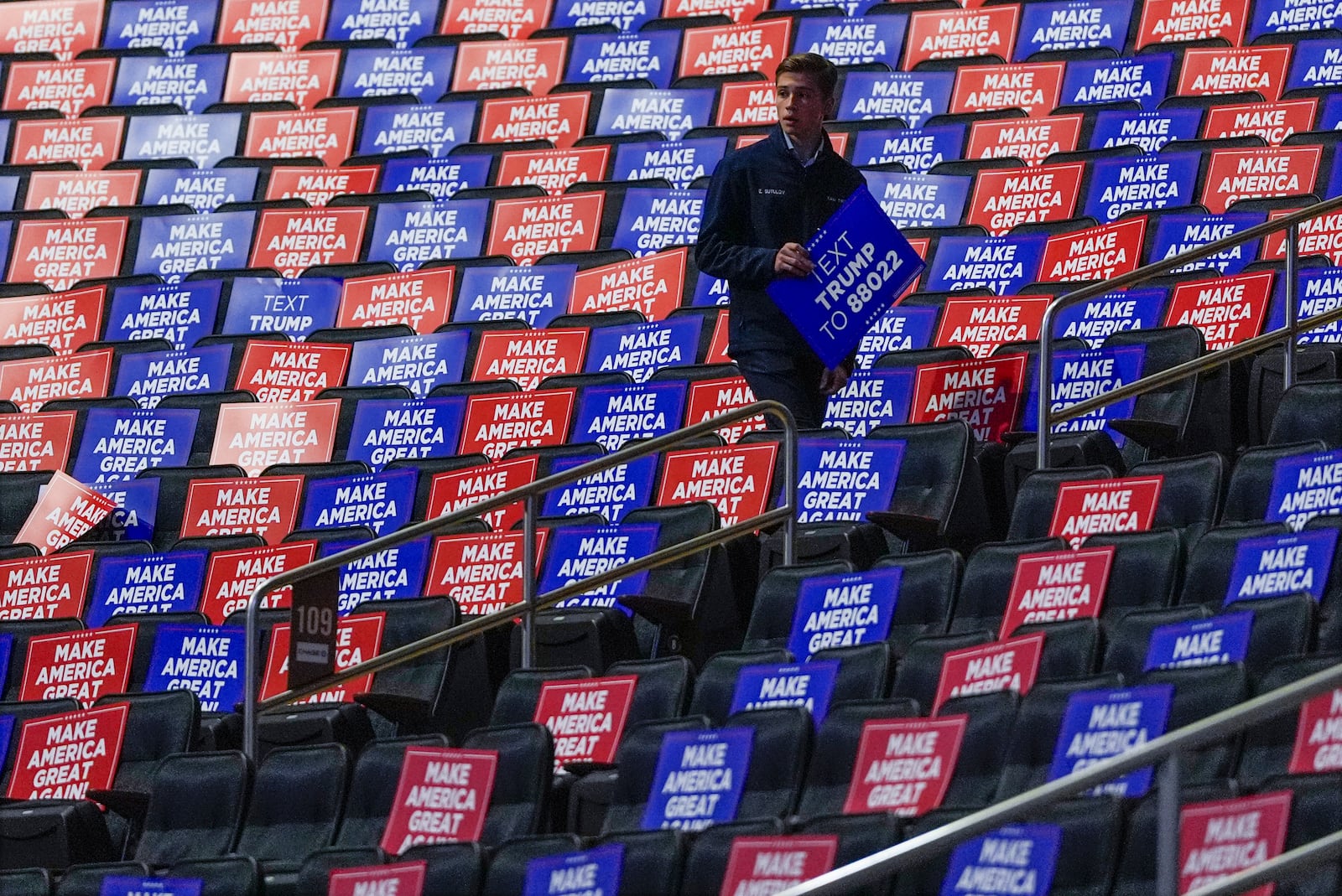 Workers place signs in seats before Republican presidential nominee former President Donald Trump speaks at a campaign rally at Madison Square Garden, Sunday, Oct. 27, 2024, in New York. (AP Photo/Julia Demaree Nikhinson)