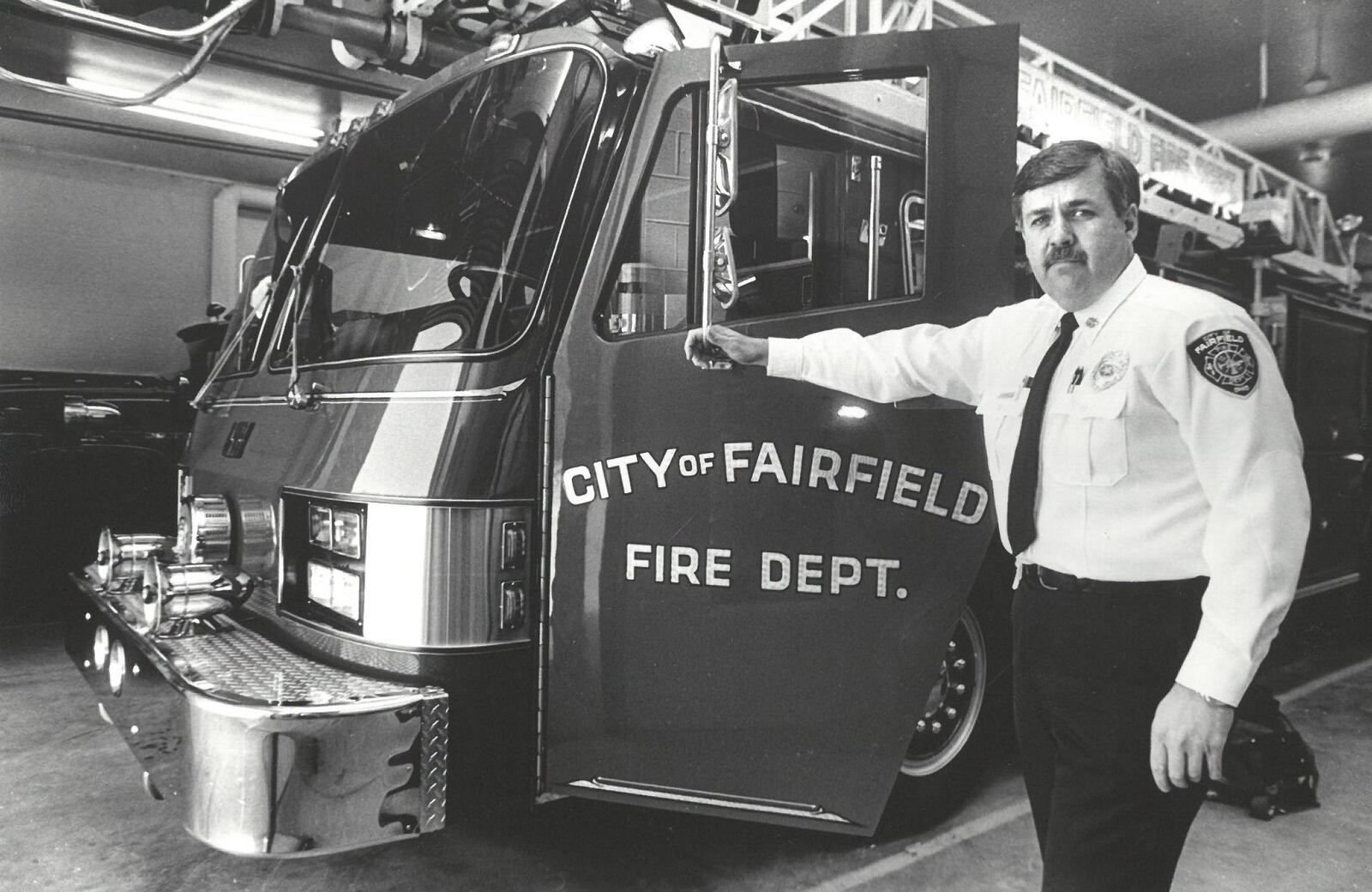 City of Fairfield Fire Chief Don Bennett is pictured next to one of the department's newer ladder and snorkel trucks at fire headquarters on Winton Road. JOURNAL-NEWS ARCHIVE PHOTOS