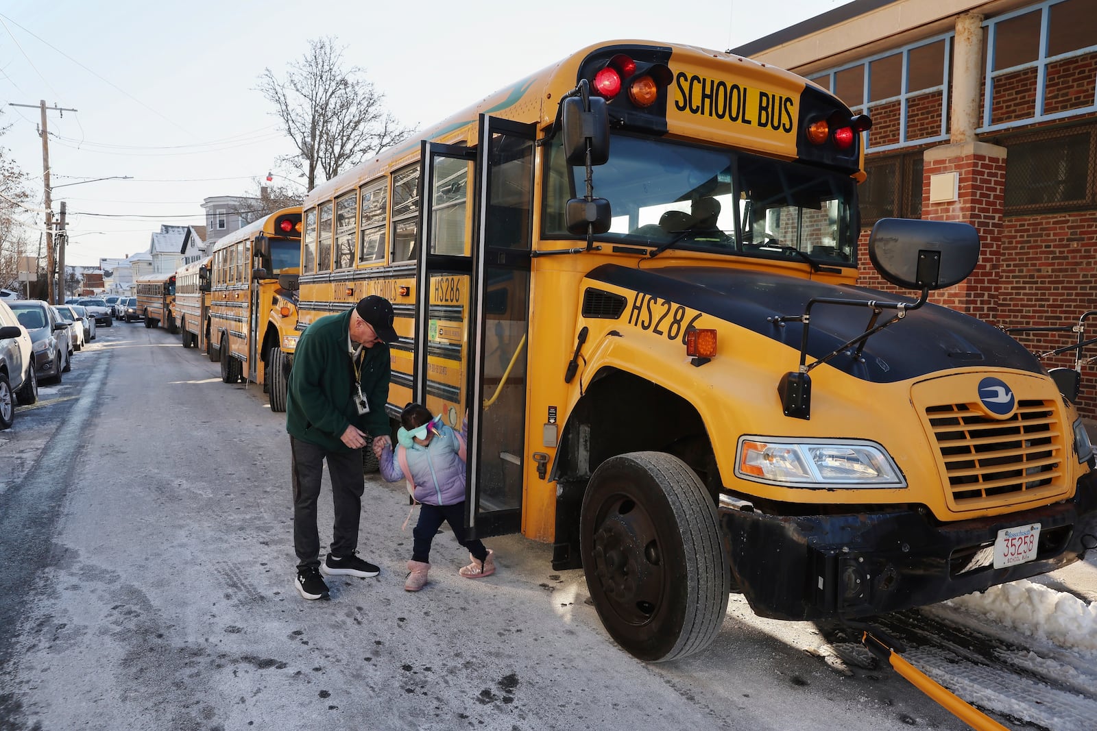 A student arrives for school Tuesday, Jan. 21, 2025, in the East Boston neighborhood of Boston. (AP Photo/Michael Dwyer)