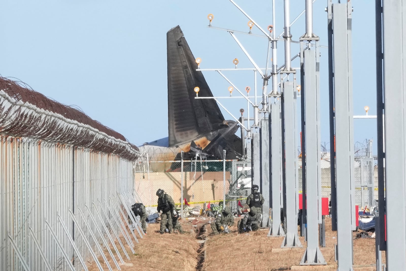 South Korean army soldiers work outside of Muan International Airport in Muan, South Korea, Tuesday, Dec. 31, 2024, following Sunday's plane crash. (AP Photo/Ahn Young-joon)