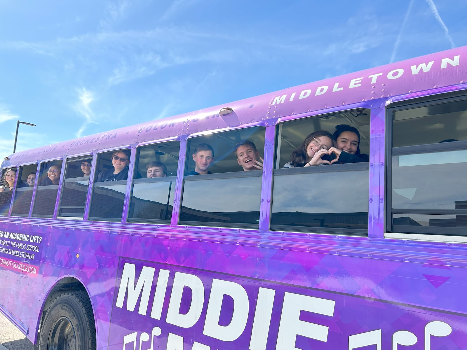 Middletown High School’s Marching Middie band, and other performing arts students from the school, will now be traveling in style in the school system’s first, decorated, dedicated school bus to transport students to football games, band contests and other performances. The colorful bus doubles as a rolling advertisement for district’s music programs. Pictured are some marching band students, performance arts teachers and others at a recent unveiling of the bus. CONTRIBUTED