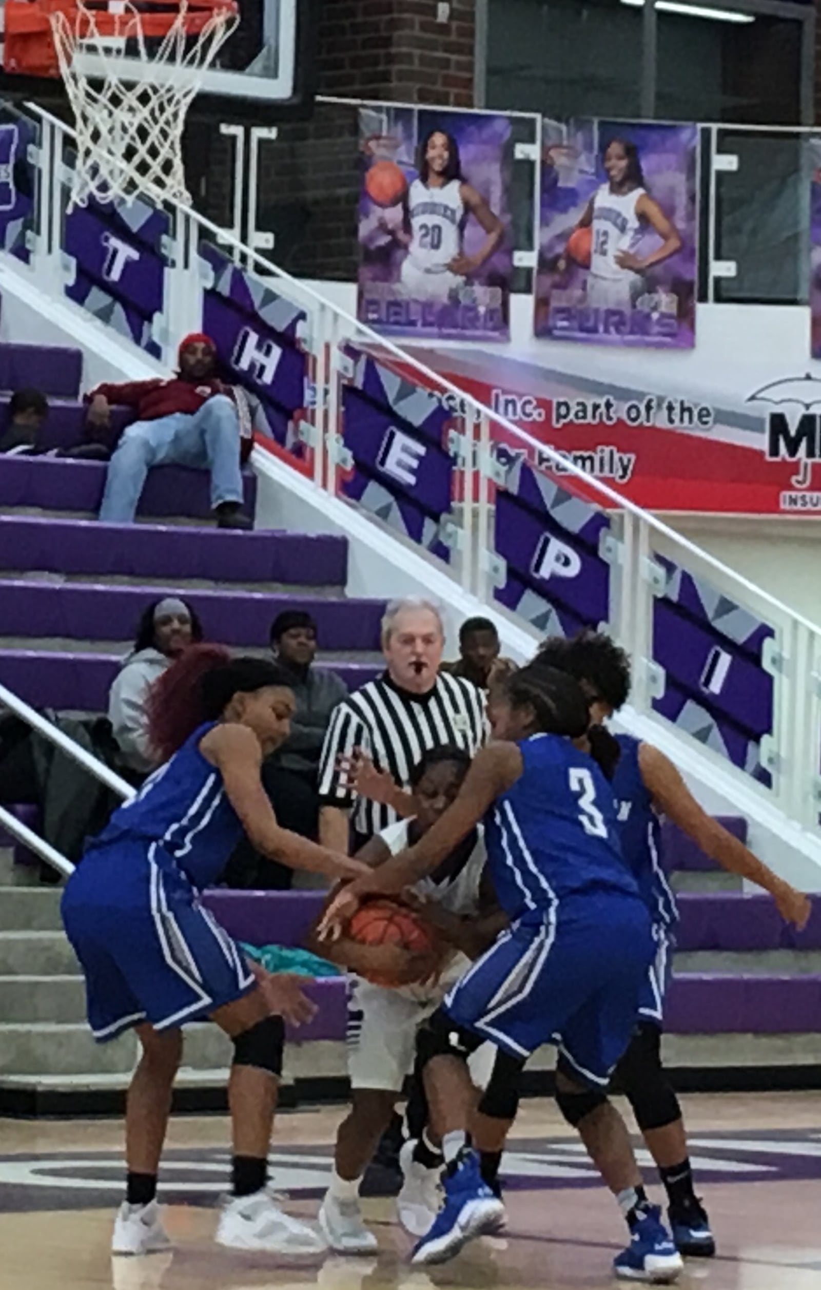 Middletown’s Aliyah Burks (12) is surrounded by Hamilton’s (from left) CiCi Riggins, Anna Cardwell and Andrea Green during Saturday afternoon’s game at Wade E. Miller Arena in Middletown. RICK CASSANO/STAFF