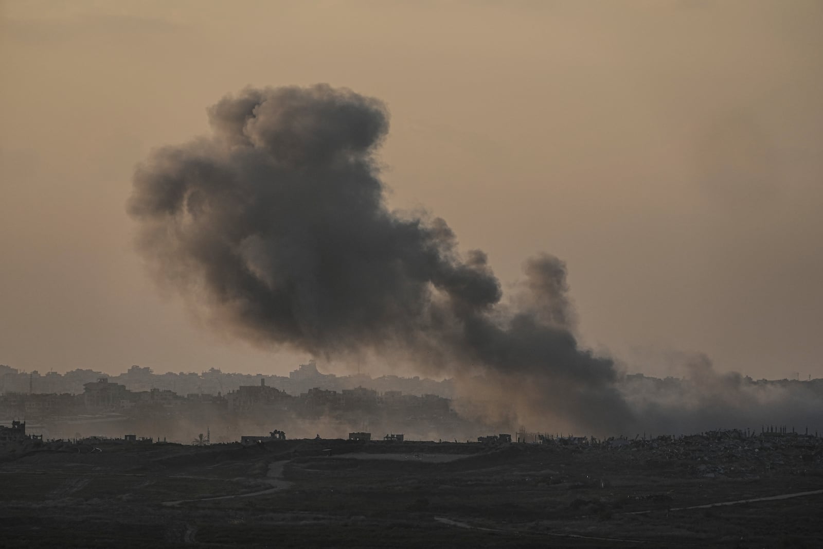 Smoke rises following an Israeli airstrike in the Gaza Strip, as seen from Sderot, southern Israel, Monday, Jan. 6, 2025. (AP Photo/Tsafrir Abayov)