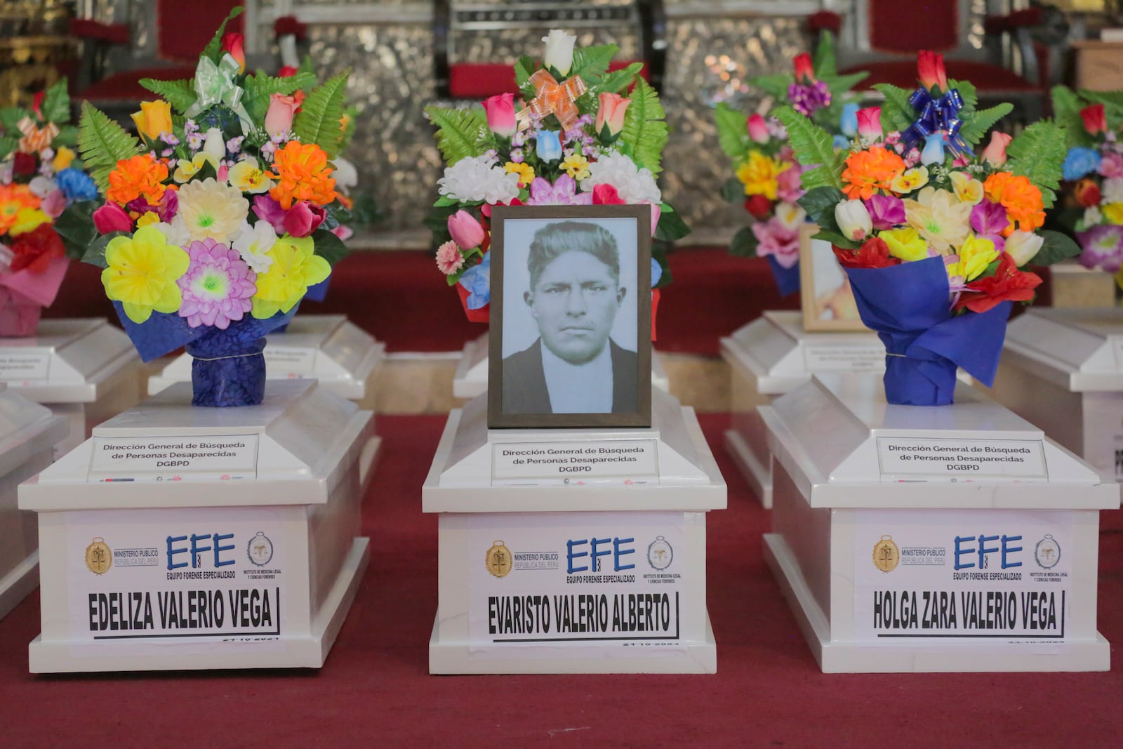 The remains of people killed during Peru's internal armed conflict (1980-2000) lie together during a funeral Mass at the Ayacucho Cathedral, after the district attorney's office identified them and returned them to families, in Ayacucho, Peru, Wednesday, Oct. 23, 2024. (AP Photo/Silvio La Rosa)