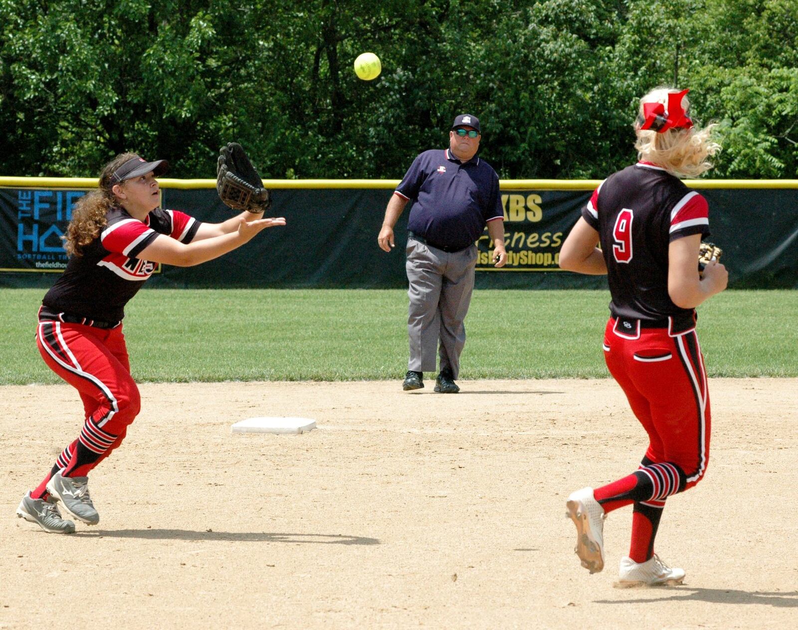 Lakota West shortstop Ariah Peregrina catches a popup in front of teammate Alyssa Triner on Saturday during a Division I regional championship softball game against Lakota East at Centerville East won 2-1. RICK CASSANO/STAFF