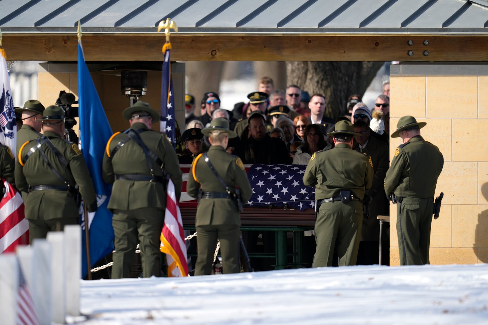 U.S. Border Patrol agent David Maland is recognized with military honors before his burial at Fort Snelling National Cemetery in Minneapolis, on Saturday, Feb. 22, 2025. (AP Photo/Abbie Parr)