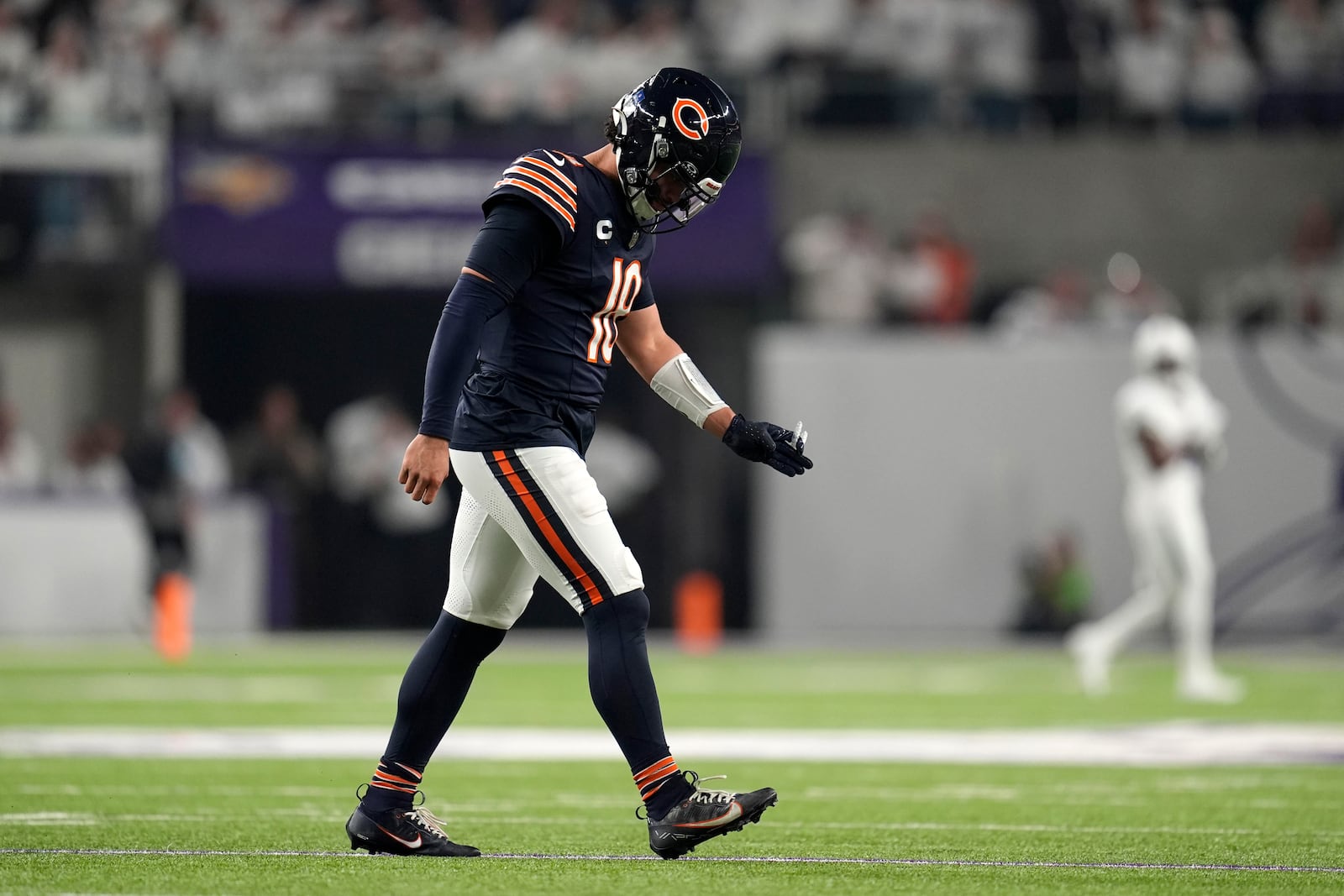 Chicago Bears quarterback Caleb Williams walks off the field after an incomplete third down pass during the first half of an NFL football game against the Minnesota Vikings, Monday, Dec. 16, 2024, in Minneapolis. (AP Photo/Abbie Parr)