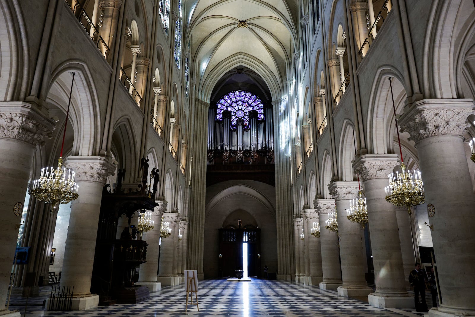 The nave, the western Rose window and the organ of Notre-Dame de Paris cathedral are seen while French President Emmanuel Macron visits the restored interiors of the monument, Friday Nov. 29, 2024, in Paris. (Stephane de Sakutin, Pool via AP)