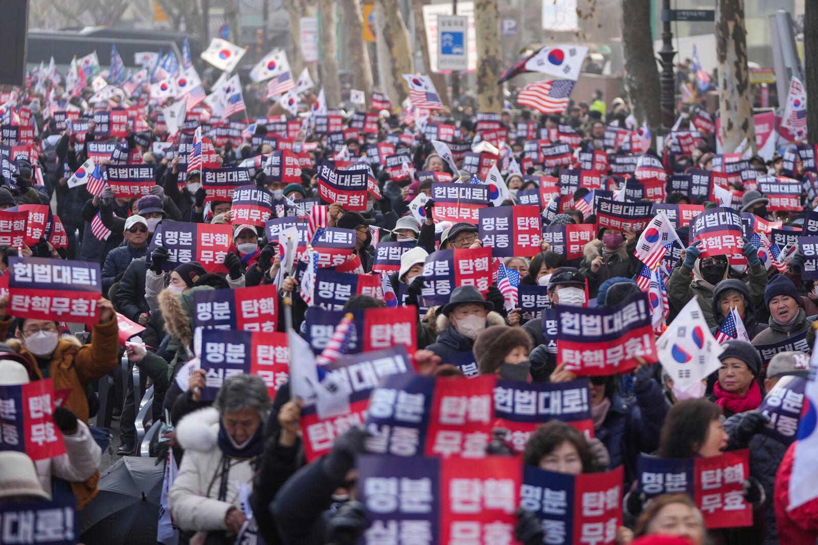 Supporters of impeached South Korean President Yoon Suk Yeol stage a rally to oppose his impeachment near the Constitutional Court in Seoul, South Korea, Tuesday, Jan. 21, 2025. The letters read "Nullity Impeachment" (AP Photo/Lee Jin-man)