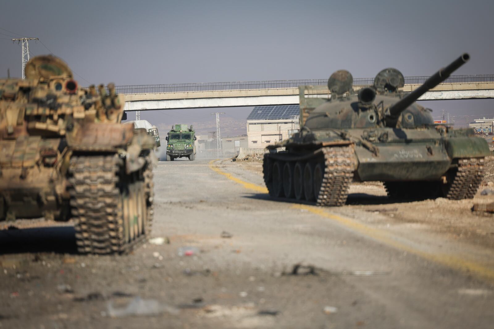 Abandoned Syrian army armoured vehicles sit on a road as opposition insurgents control the outskirts of Hama, Syria, Tuesday Dec. 3, 2024.(AP Photo/Ghaith Alsayed)