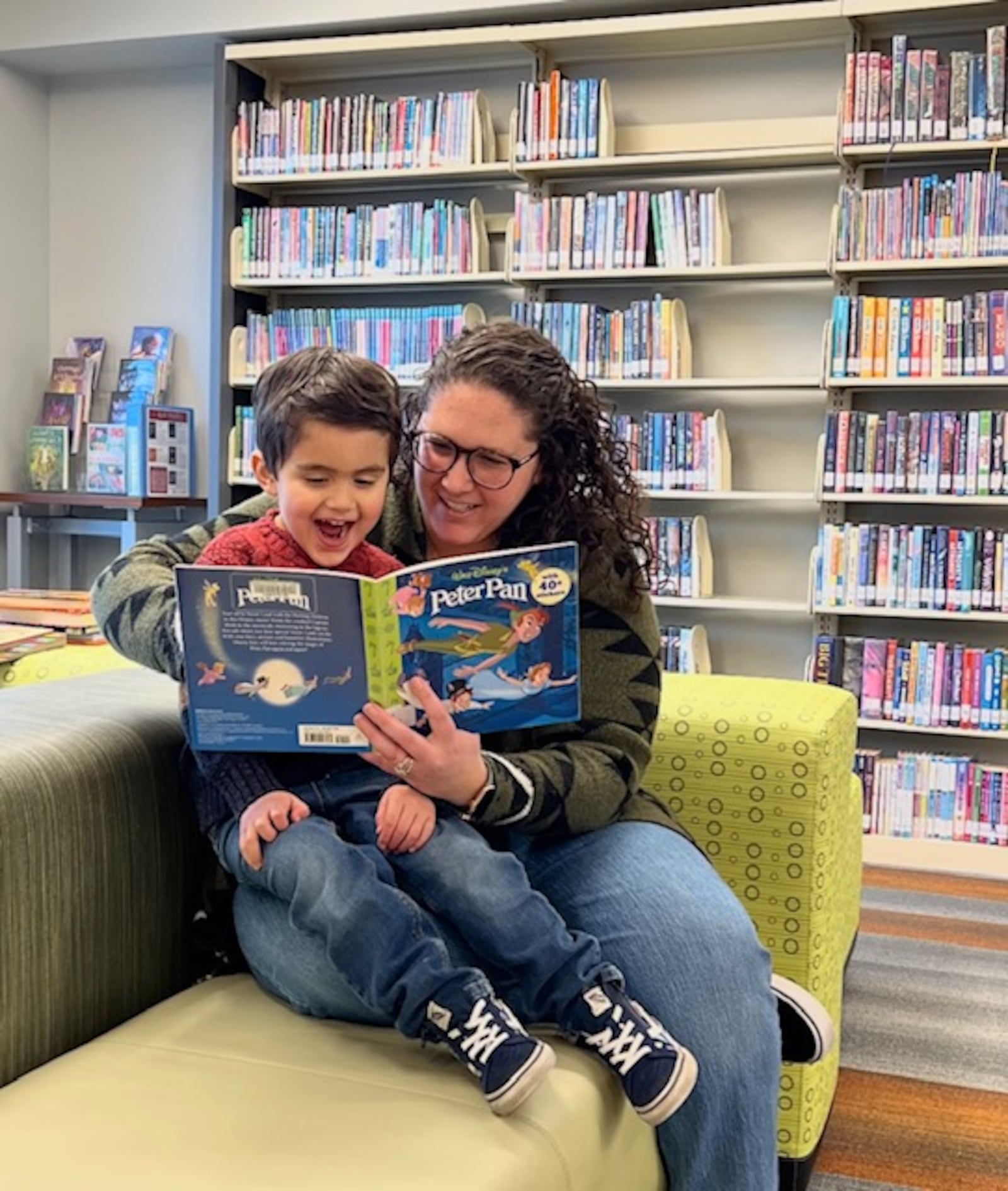 Jamie Garcia, Youth Services Team Liaison for the Washington- Centerville Public Library, reads "Peter Pan" to her son, Lorenzo.