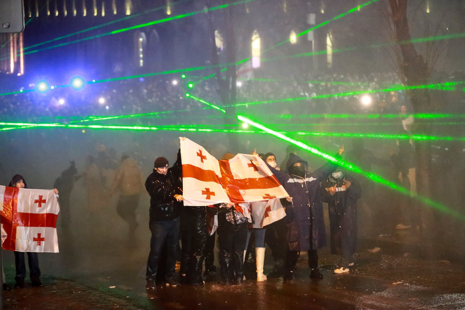 Police use a water cannon to block protesters holding Georgian national flags during a rally against the governments' decision to suspend negotiations on joining the European Union for four years, outside the parliament's building in Tbilisi, Georgia, on Sunday, Dec. 1, 2024. (AP Photo/Zurab Tsertsvadze)