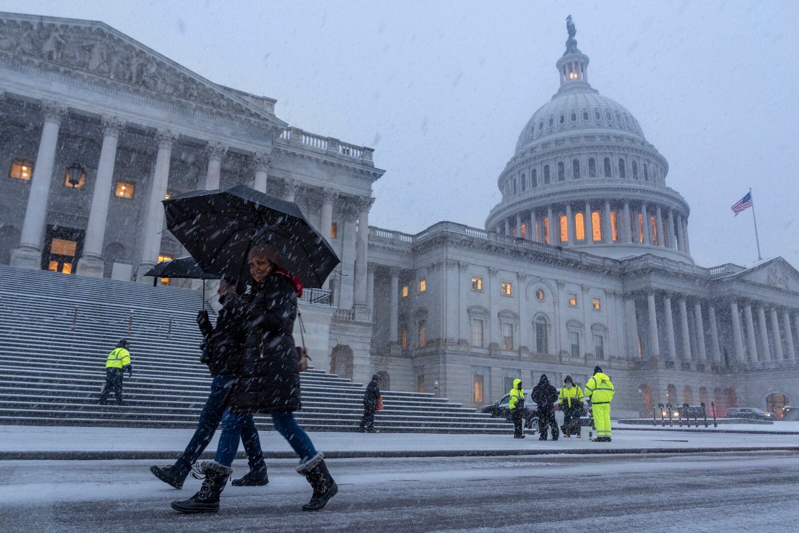 People walk through snow at the Capitol, Tuesday, Feb. 11, 2025, during a snowstorm in Washington. (AP Photo/Jacquelyn Martin)