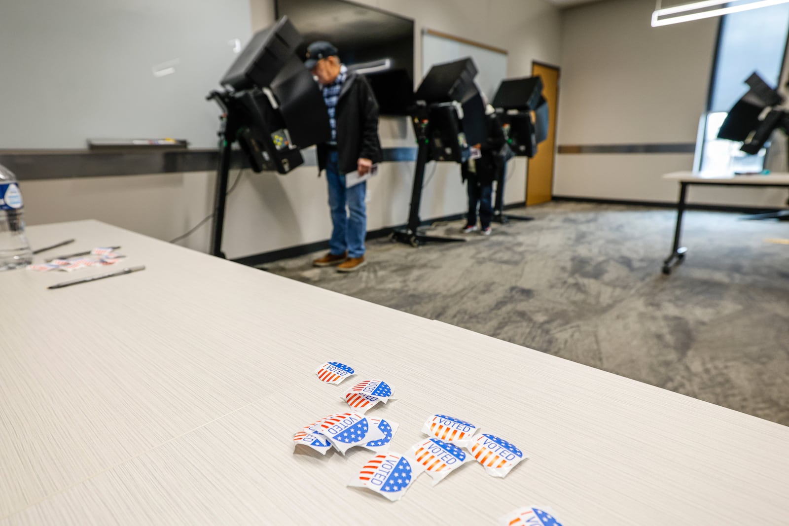 Stickers on a table as people cast ballots during early voting in Waukesha, Wis., Tuesday, March 18, 2025. (AP Photo/Jeffrey Phelps)