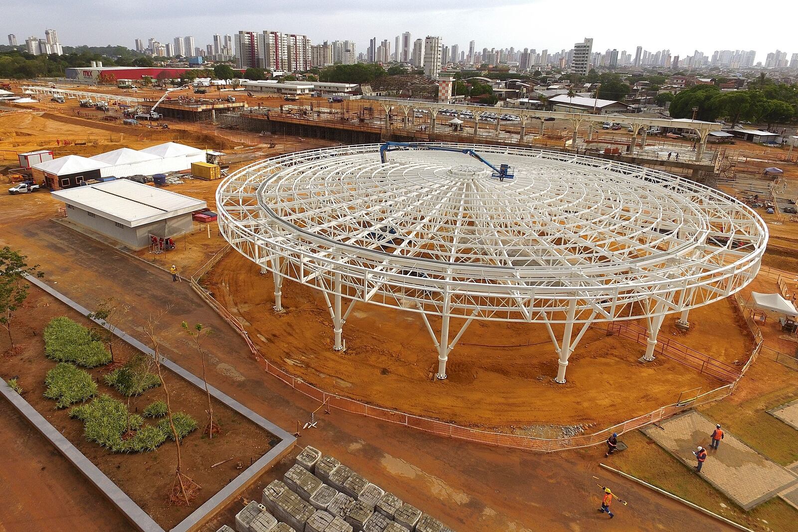 FILE - Construction workers walk around Parque da Cidade, or City Park, in Belem, Brazil, Sept. 24, 2024, a project being built for the COP30 U.N. Climate Summit. (AP Photo/Paulo Santos, File)