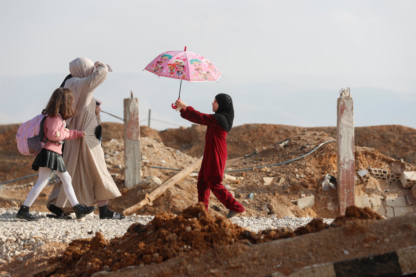 A family arrive to cross into Lebanon through the Jousieh border crossing, between Syria and Lebanon, Thursday, Nov. 28, 2024, following a ceasefire between Israel and Hezbollah that went into effect on Wednesday. (AP Photo/Omar Sanadiki)