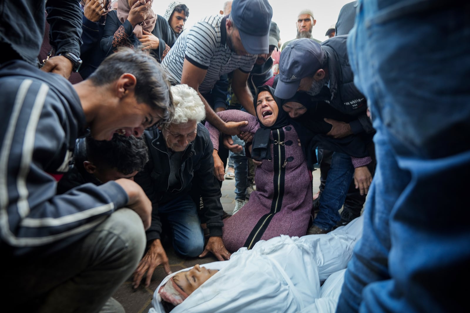 FILE - Palestinians mourn their relatives killed in the Israeli bombardment of the Gaza Strip at a hospital morgue in Deir al-Balah, Tuesday, Oct. 29, 2024. (AP Photo/Abdel Kareem Hana, File)