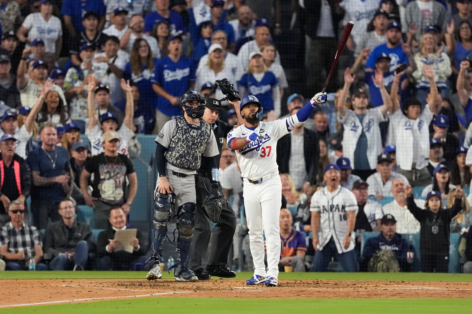 Los Angeles Dodgers' Teoscar Hernández watches his two-run home run during the third inning in Game 2 of the baseball World Series against the New York Yankees, Saturday, Oct. 26, 2024, in Los Angeles. (AP Photo/Mark J. Terrill)