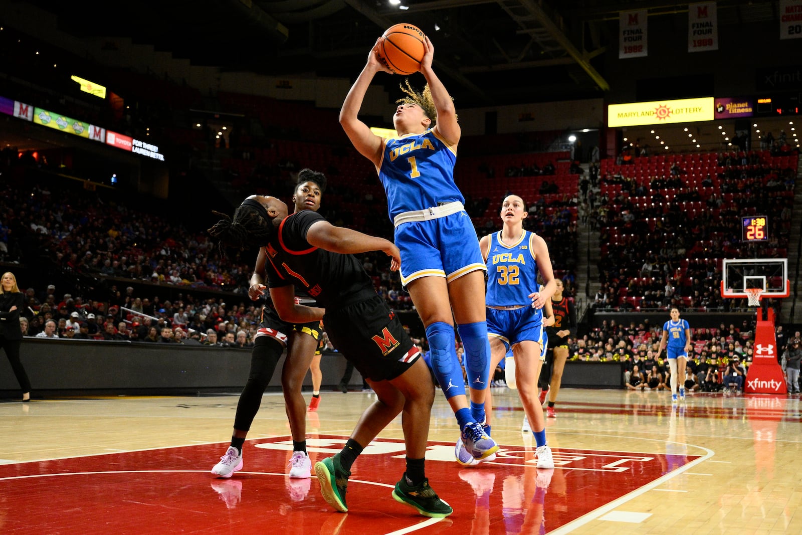 UCLA guard Kiki Rice, front right, is fouled by Maryland guard Sarah Te-Biasu, front left, during the first half of an NCAA college basketball game, Sunday, Jan. 26, 2025, in College Park, Md. (AP Photo/Nick Wass)