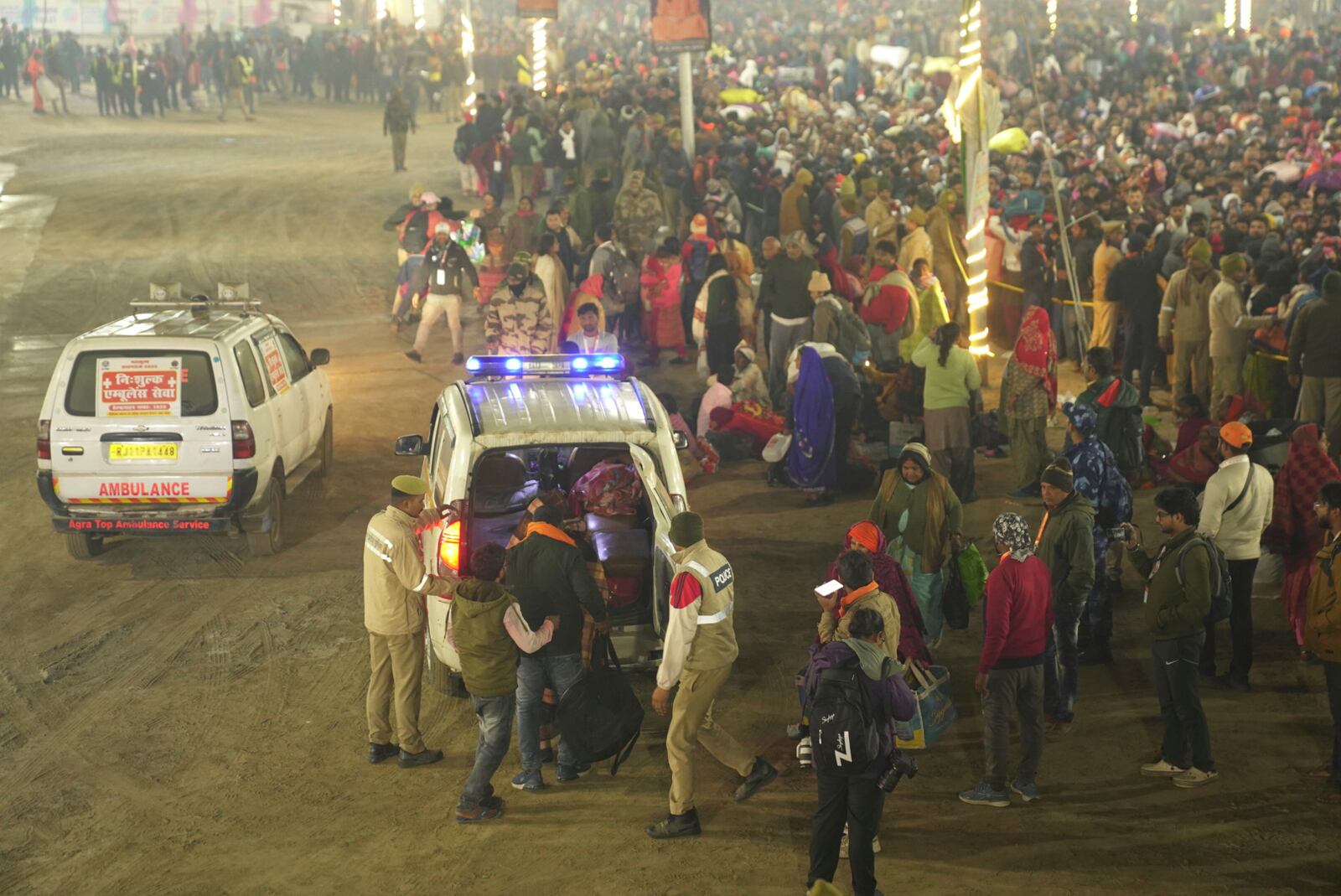 Security officers guide devotees into an ambulance at the site of a stampede on the Sangam, the confluence of the Ganges, the Yamuna and the mythical Saraswati rivers, on "Mauni Amavasya" or new moon day during the Maha Kumbh festival, in Prayagraj, Uttar Pradesh, India, Wednesday, Jan. 29, 2025. (AP Photo)