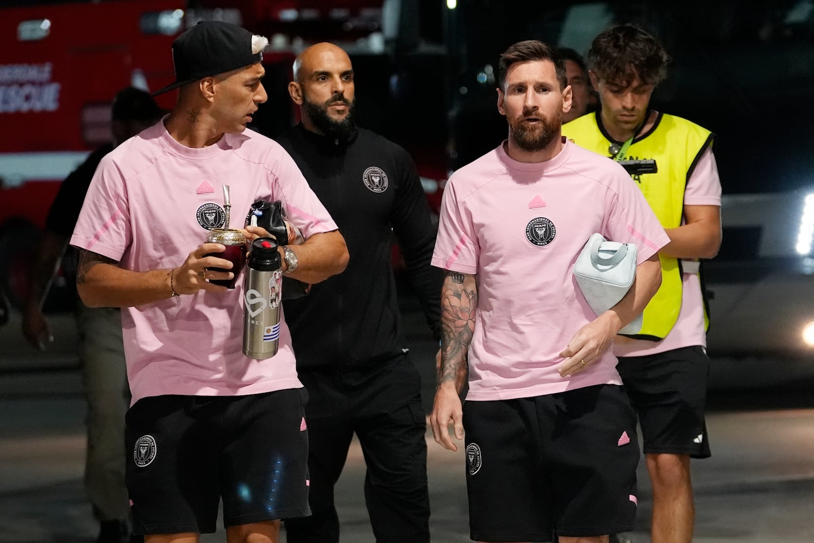 Inter Miami forwards Luis Suárez, left and Lionel Messi arrive for match one of their MLS playoff opening round soccer match against Atlanta United, Friday, Oct. 25, 2024, in Fort Lauderdale, Fla. (AP Photo/Lynne Sladky)