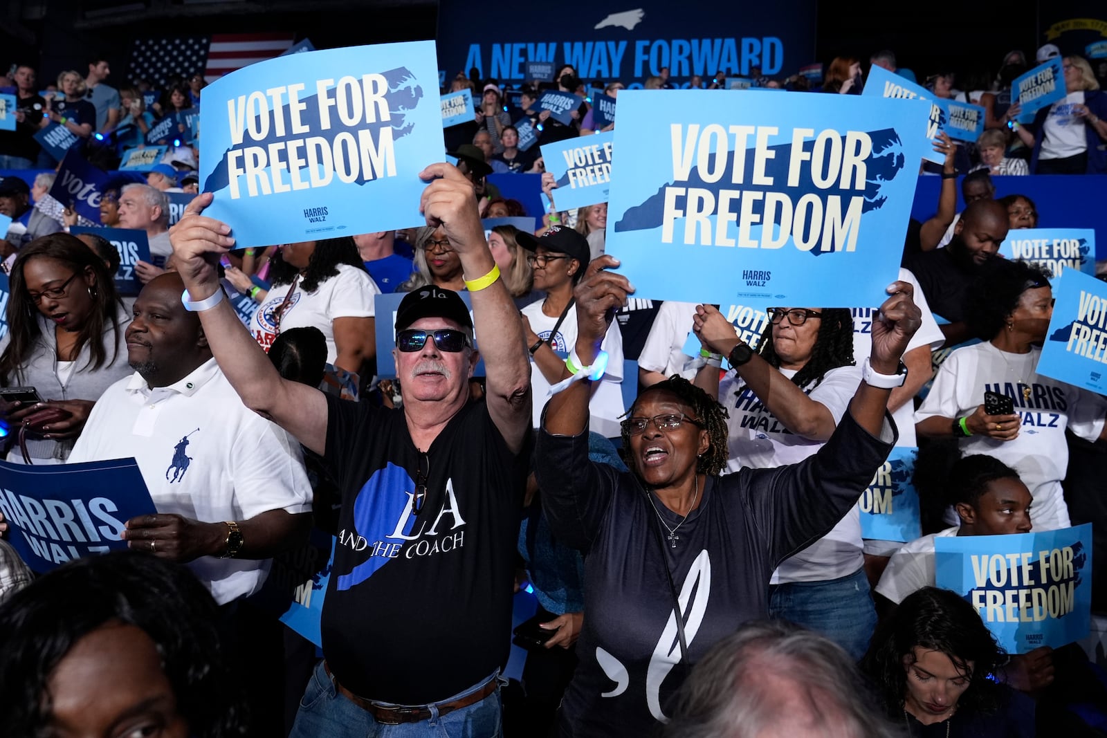 Attendees hold up signs before Democratic presidential nominee Vice President Kamala Harris arrives to speak at a campaign rally at East Carolina University in Greenville, N.C., Sunday, Oct. 12, 2024. (AP Photo/Susan Walsh)