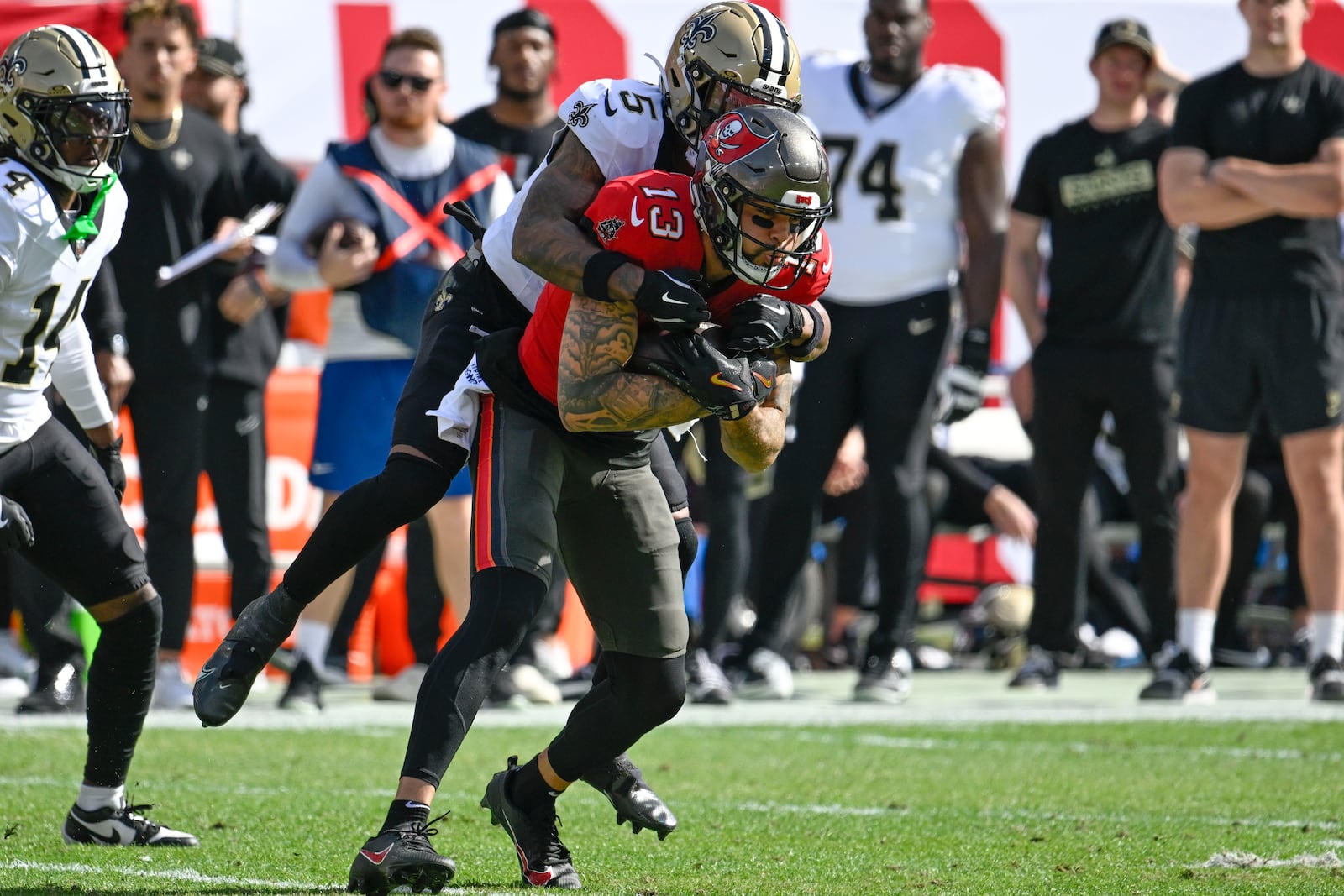 Tampa Bay Buccaneers wide receiver Mike Evans (13) pulls in a pass against New Orleans Saints cornerback Will Harris (5) during the first half of an NFL football game Sunday, Jan. 5, 2025, in Tampa, Fla. (AP Photo/Jason Behnken)