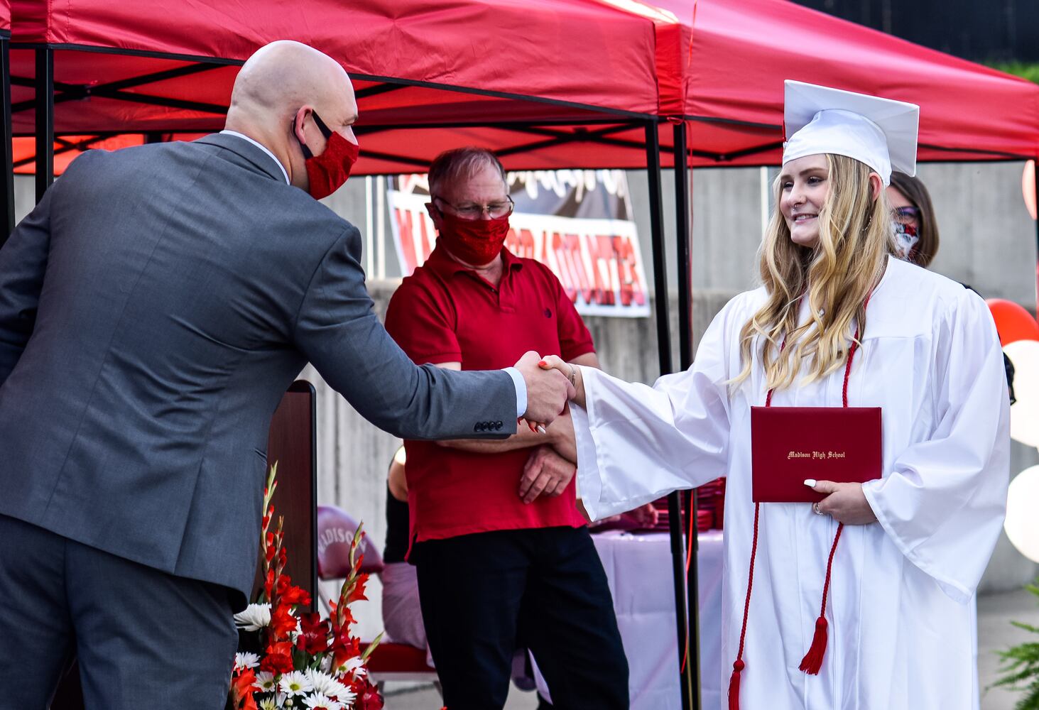 Madison High School drive-thru graduation ceremony at Land of Illusion