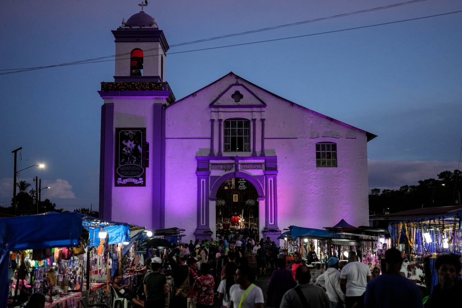 Pilgrims arrive at San Felipe Church to honor the Black Christ in Portobelo, Panama, at dawn Monday, Oct. 21, 2024, during a festival celebrating the iconic statue that was found on the shore in 1658. (AP Photo/Matias Delacroix)