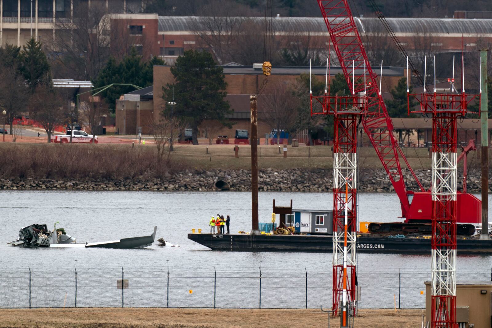 Rescue and salvage crews with cranes work near the wreckage of an American Airlines jet in the Potomac River from Ronald Reagan Washington National Airport, Sunday, Feb. 2, 2025, in Arlington, Va. (AP Photo/Jose Luis Magana)