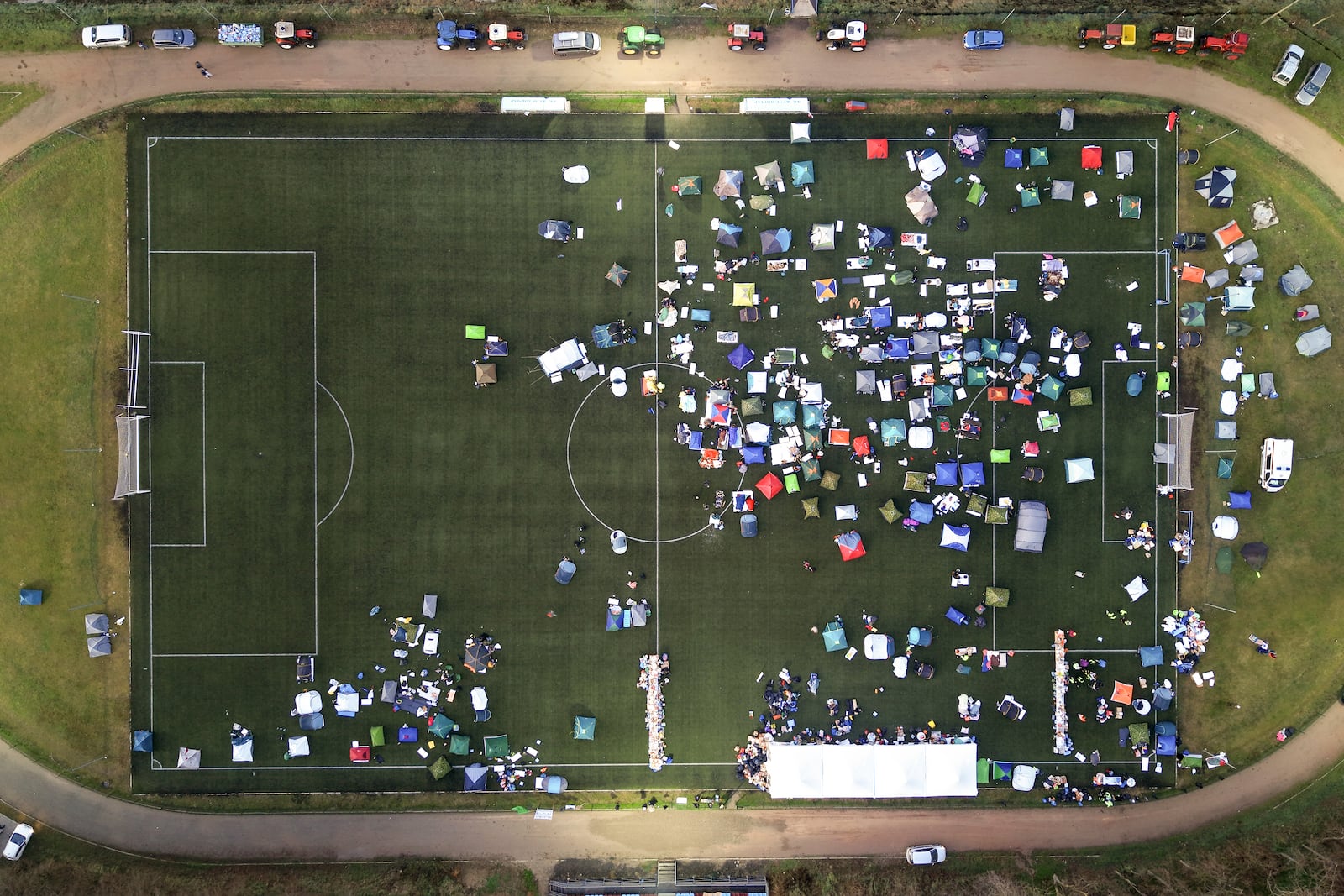 An aerial view of students sleeping in their tents on a soccer stadium as they take part in a march and protest over the collapse of a concrete canopy that killed 15 people more than two months ago, in Indjija, Serbia, Friday, Jan. 31, 2025. (AP Photo/Armin Durgut)